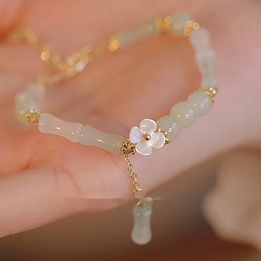 Dainty multi-bead jade-green and mother-of-pearl flower bracelet