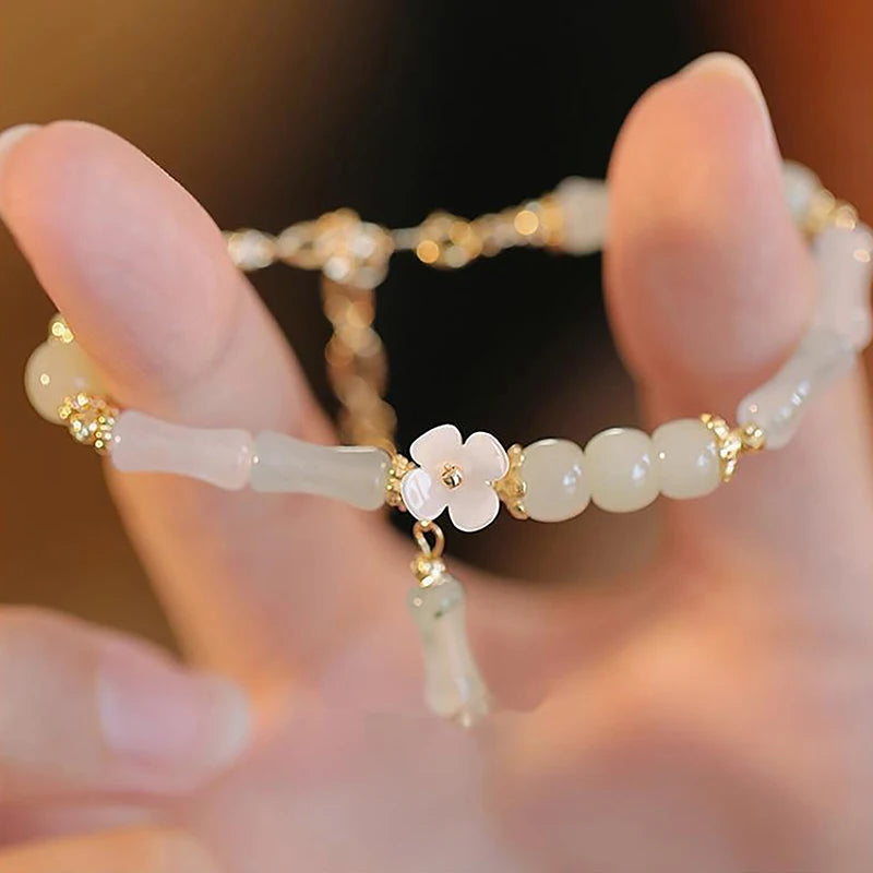 Dainty multi-bead jade-green and mother-of-pearl flower bracelet