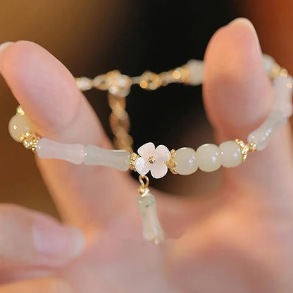 Dainty multi-bead jade-green and mother-of-pearl flower bracelet