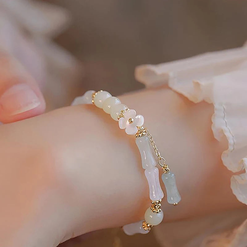 Dainty multi-bead jade-green and mother-of-pearl flower bracelet