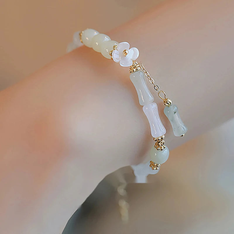 Dainty multi-bead jade-green and mother-of-pearl flower bracelet