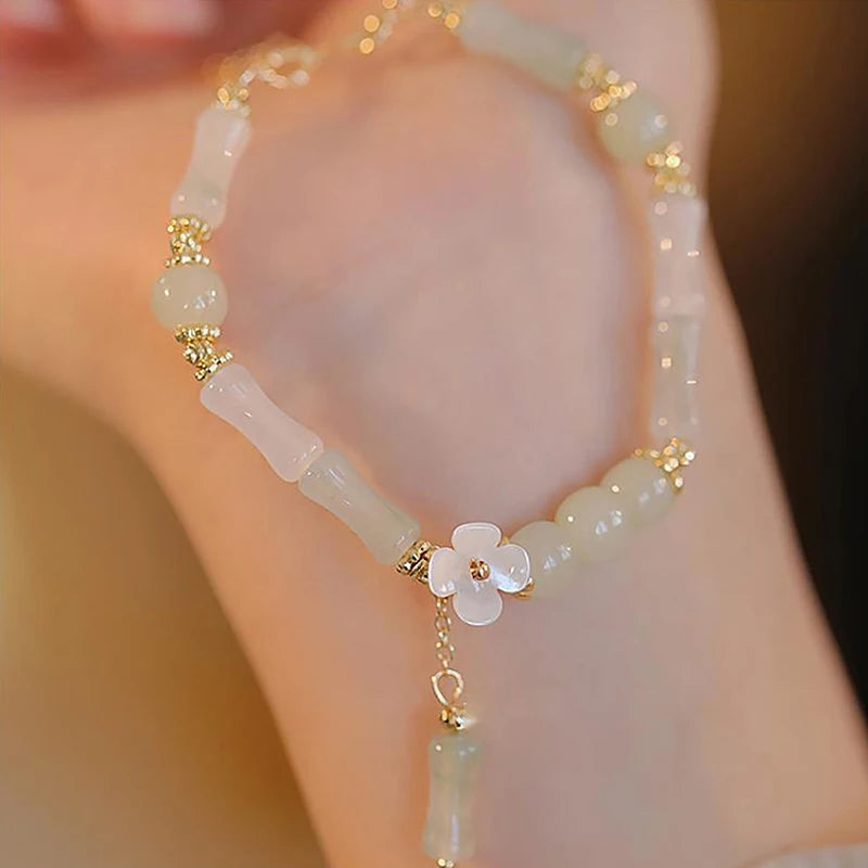 Dainty multi-bead jade-green and mother-of-pearl flower bracelet