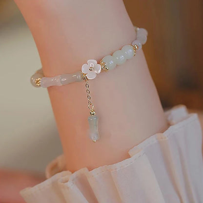 Dainty multi-bead jade-green and mother-of-pearl flower bracelet